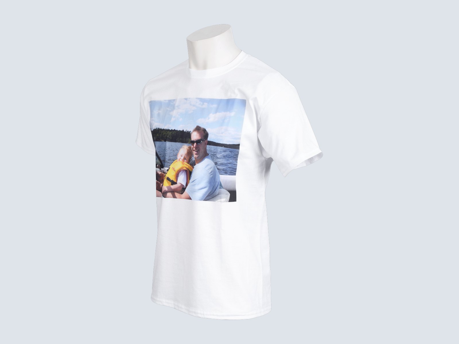 A white T-shirt printed with a photo of a father and child on a boat