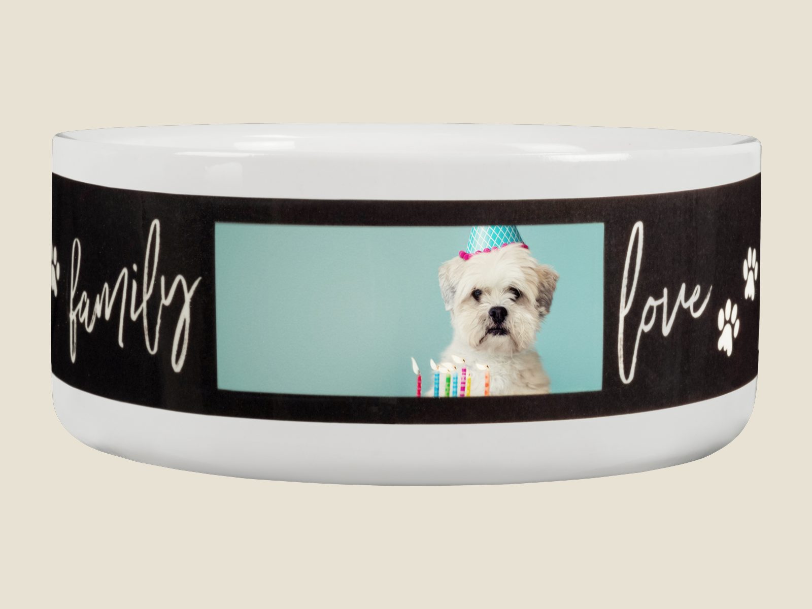 A white ceramic pet bowl with a dog’s birthday photo and the words family and love