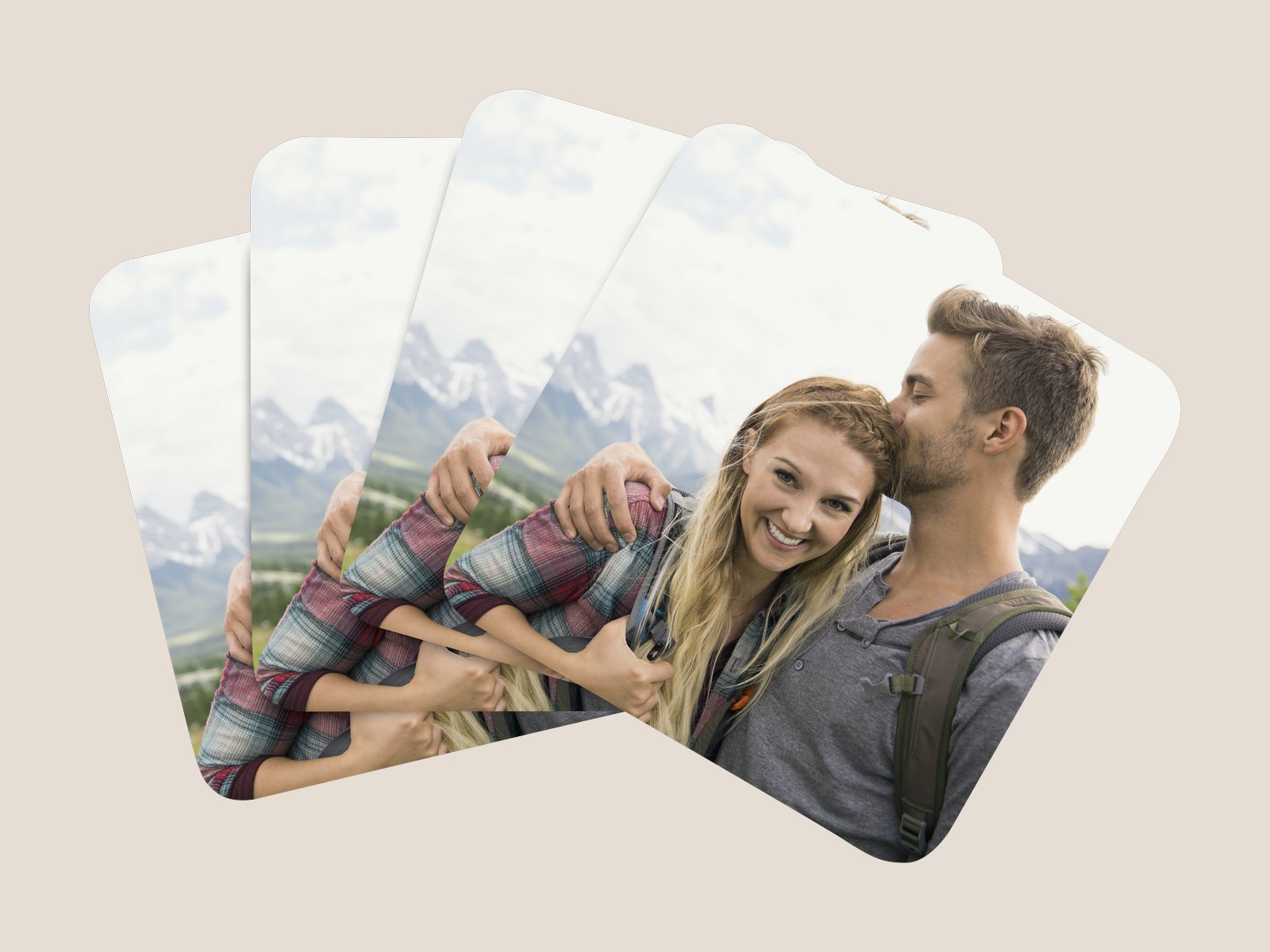 A fanned set of four photo coasters with a couple’s photo