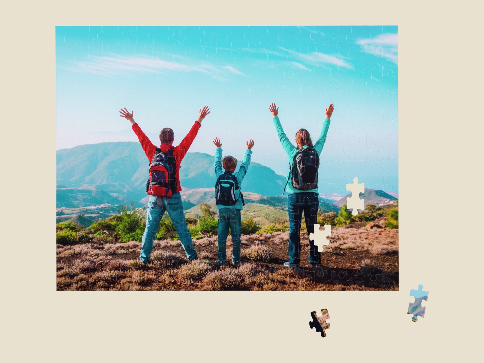 A photo puzzle of a family on a mountain top, with loose pieces