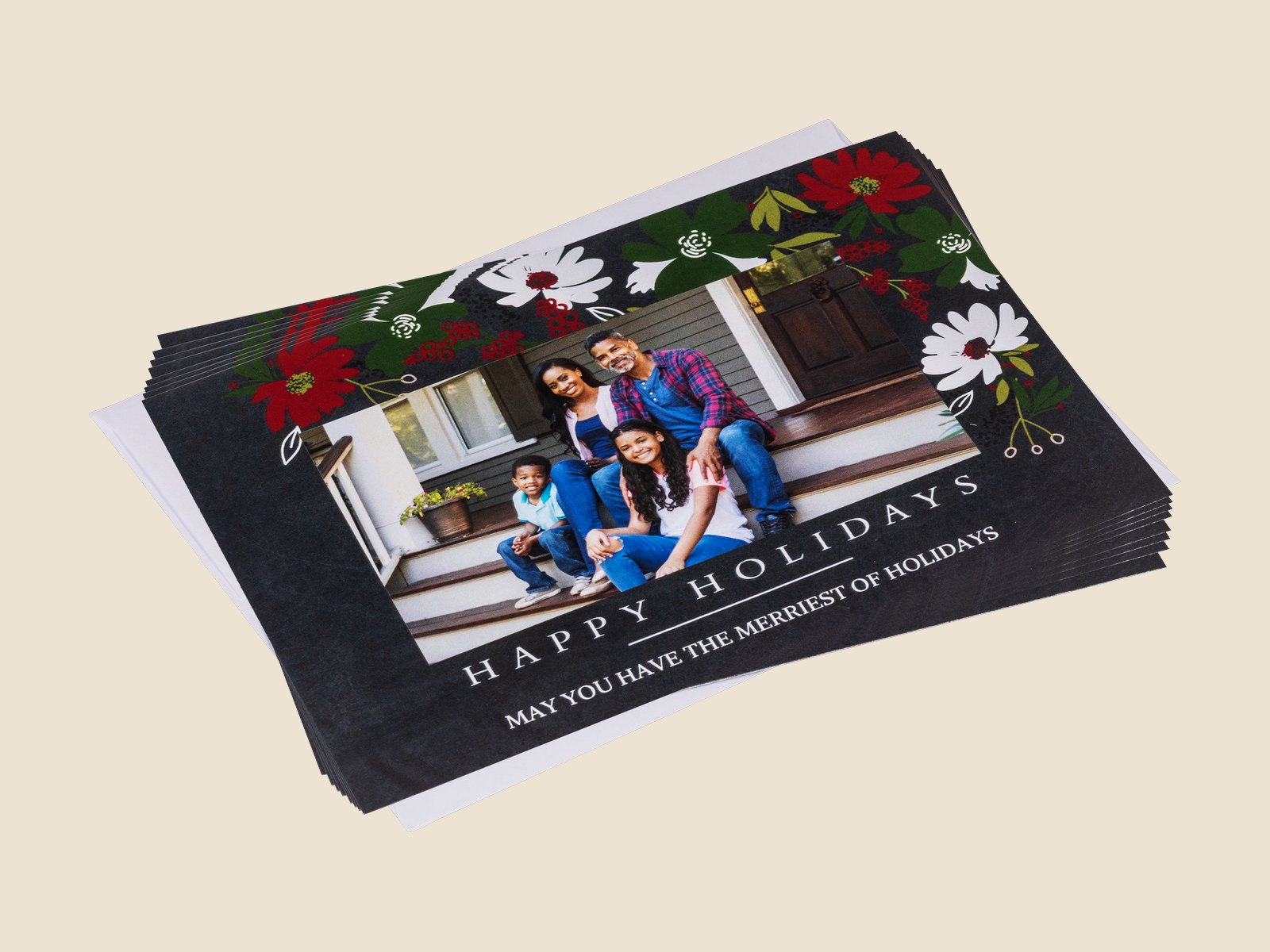 A stack of 5x7 holiday stationery cards with a family photo and floral border