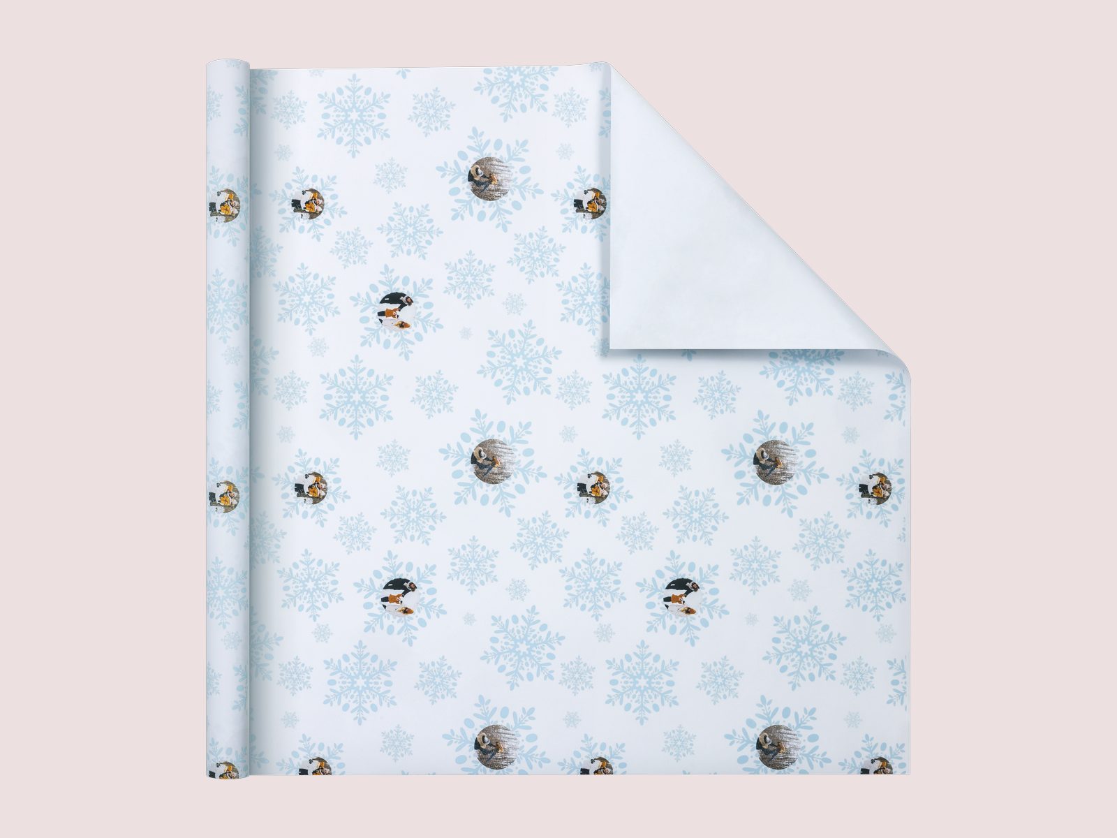 A sheet of wrapping paper with a repeating pet photo among snowflakes