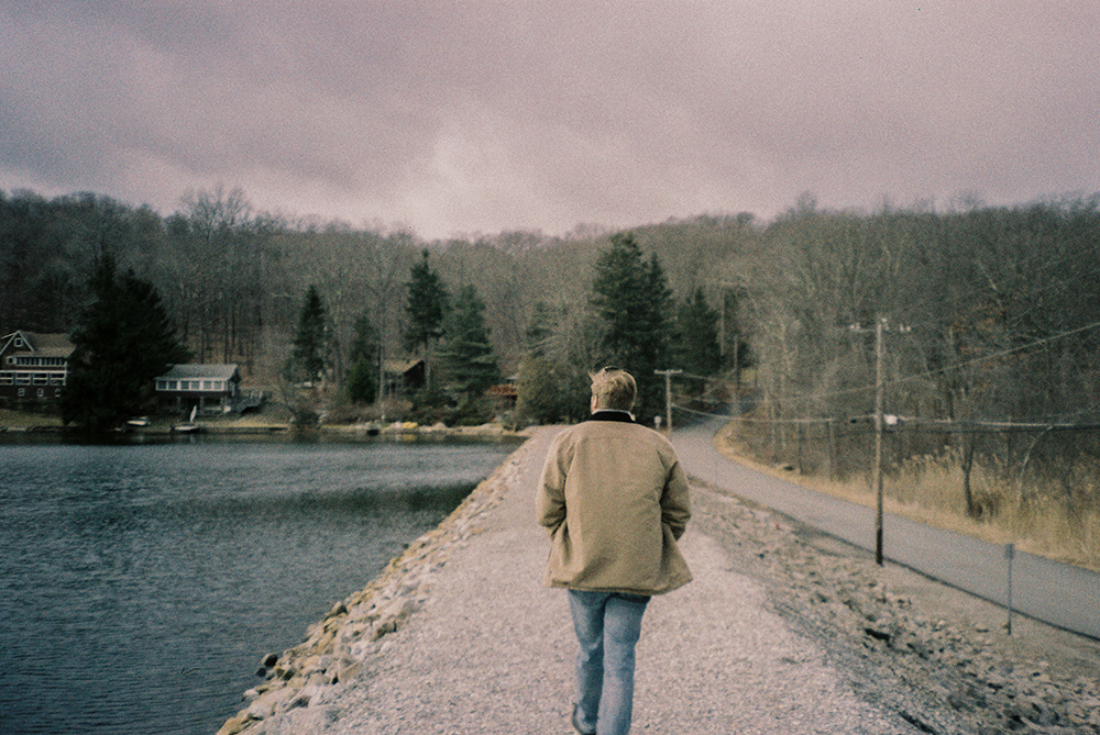 Photo of a person walking through a hike trail taken with Lomography Metropolis Film
