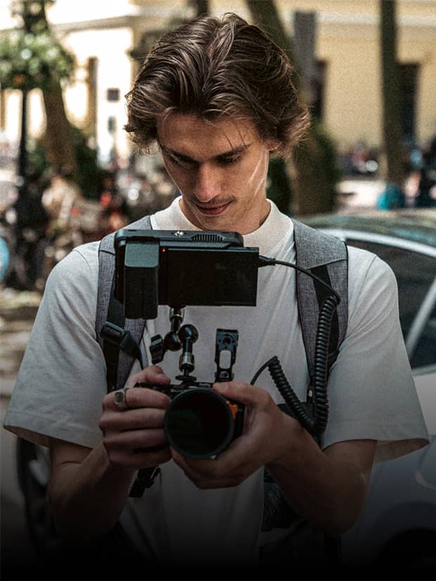 A student filmmaker checking a shot on a camera rig
